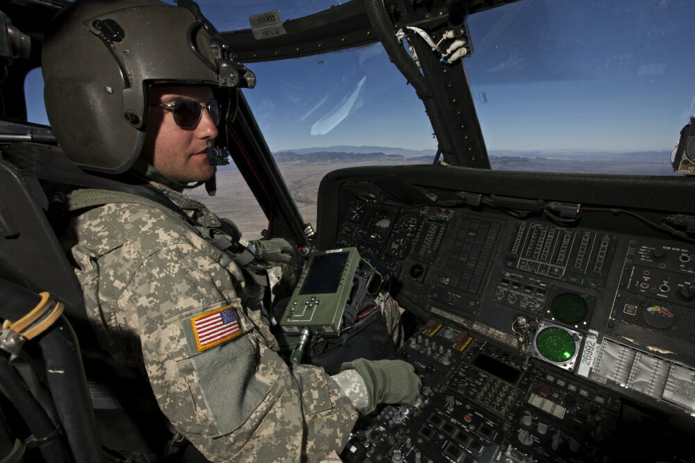 Posterazzi: Pilot operating the cockpit of a UH-60 Black Hawk ...