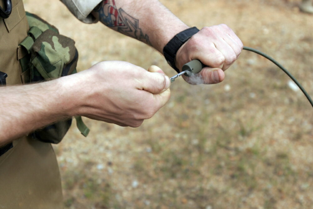 Posterazzi: A soldier pulls a detonation cord igniter to start a ...